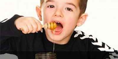 boy eating honey