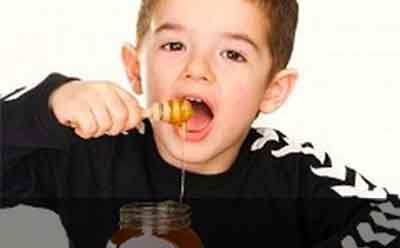 boy eating honey