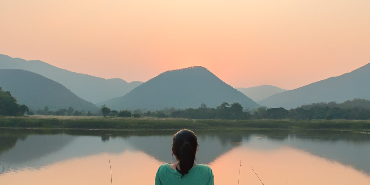 Woman Meditating in Personal Peace near Lake