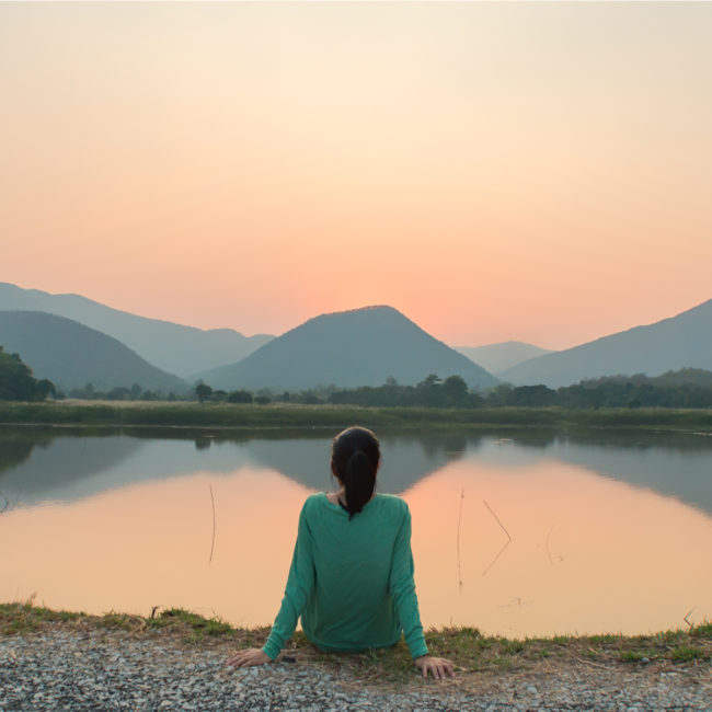 Woman Meditating in Personal Peace near Lake